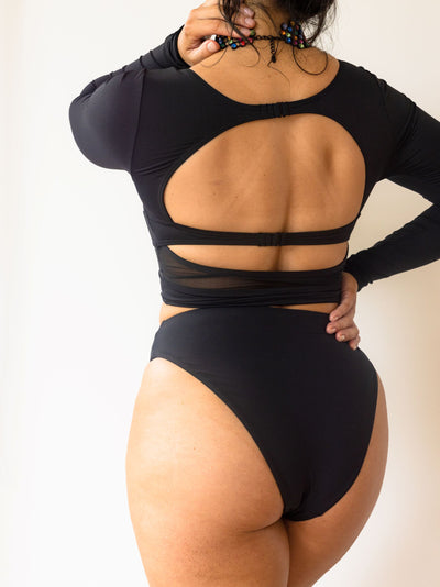 The Dip rash guard in black back details worn with black high waist bikini bottoms