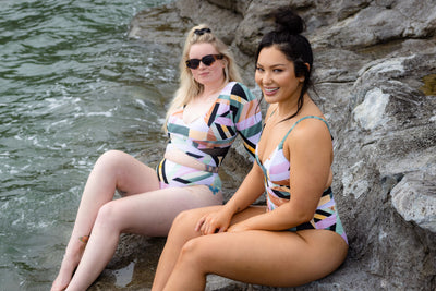 SWMR The Dip rash guard in print worn at the beach with another model wearing a print swimsuit